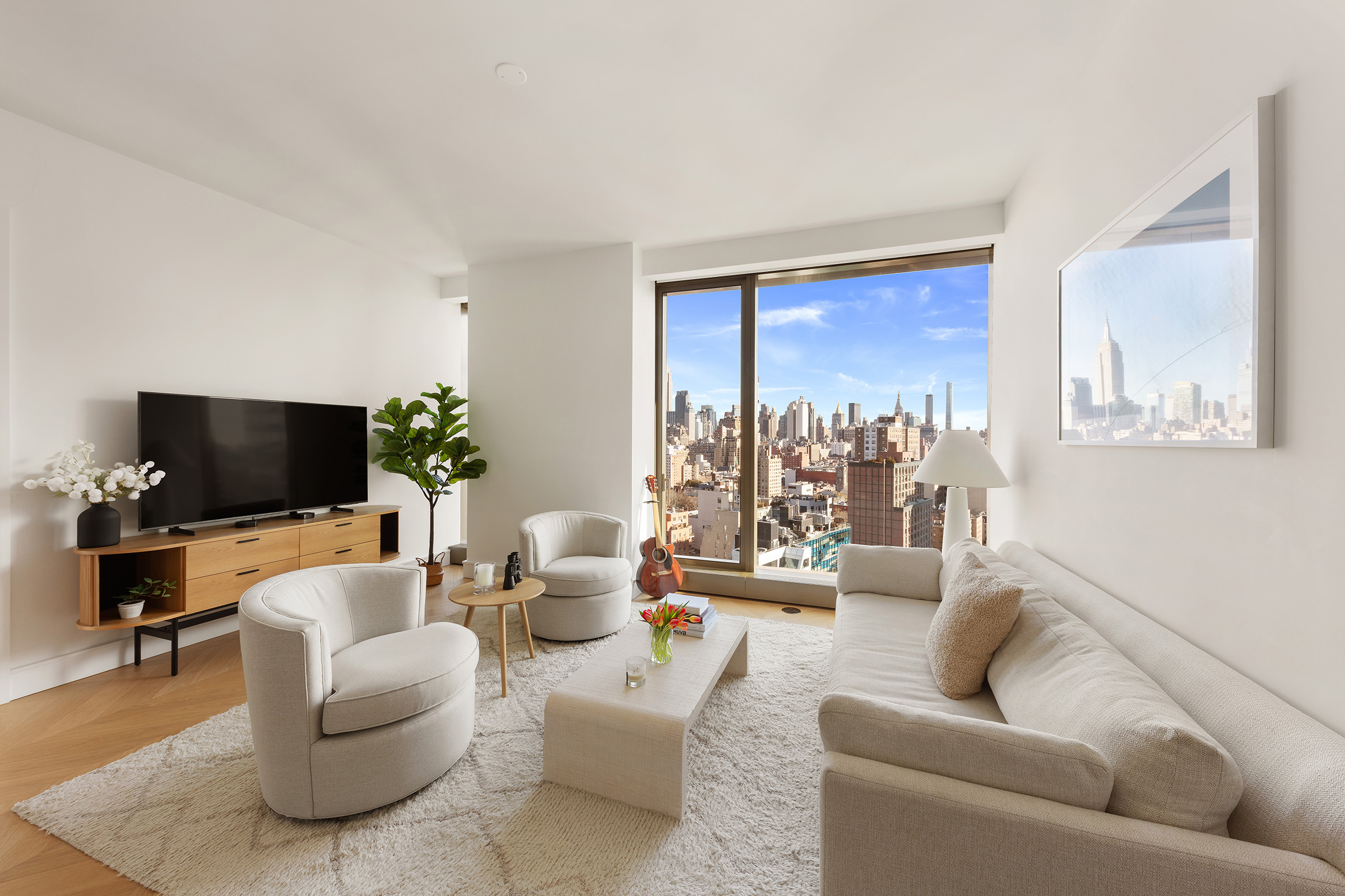 500 West 18th Street, Unit EAST 19E Manhattan, NY 10011 - Photo 4 of 18 a living room with furniture and a flat screen tv