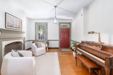 a living room with furniture a fireplace and a window