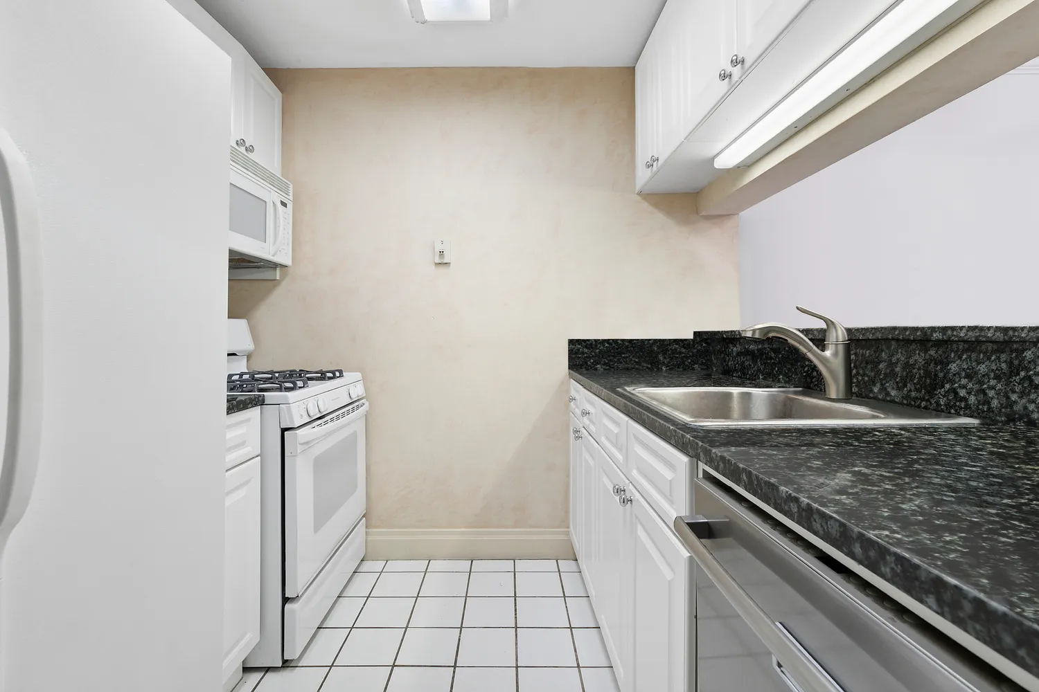 a kitchen with a sink cabinets and stainless steel appliances