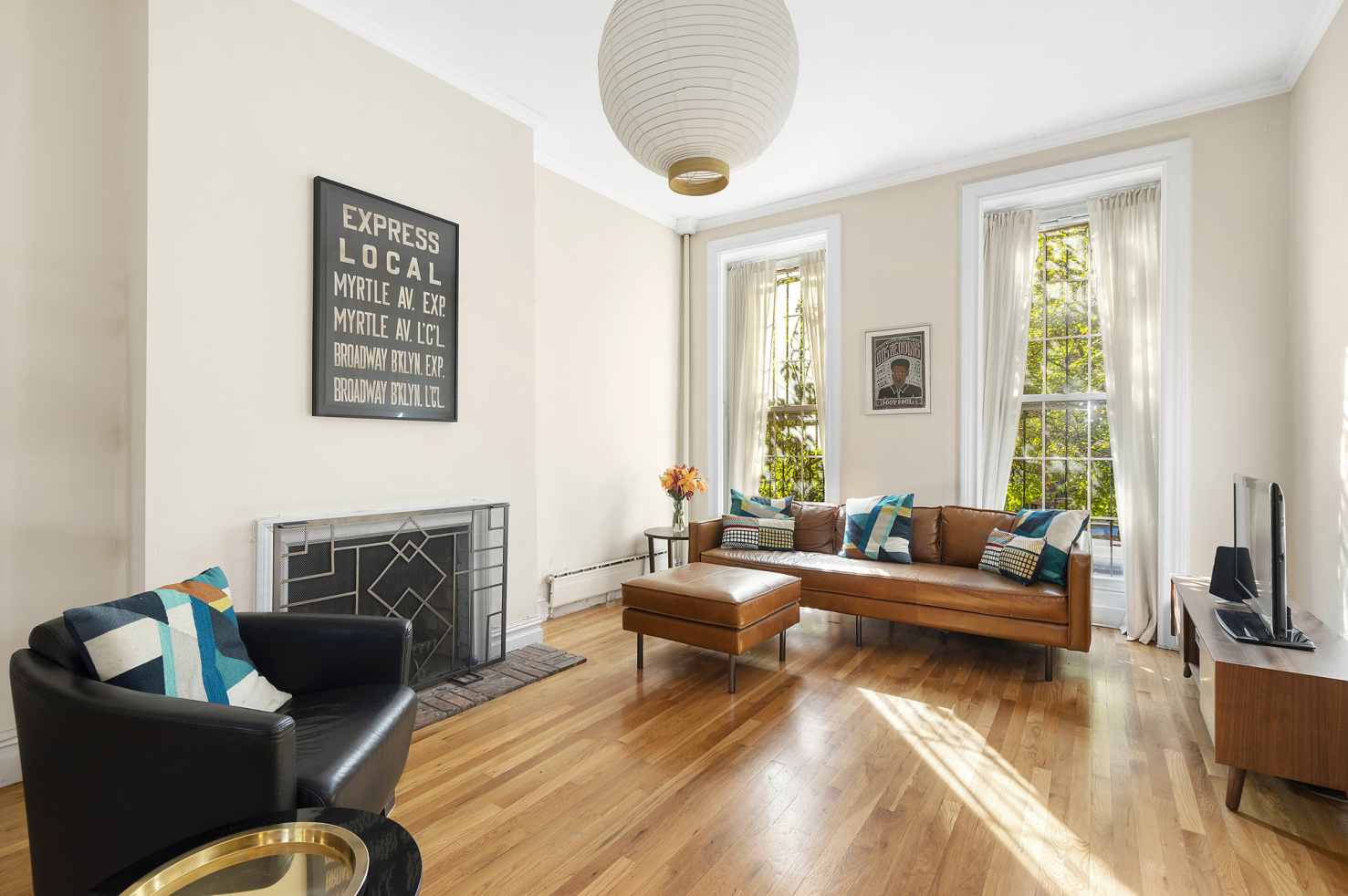 a living room with furniture fireplace and a large window