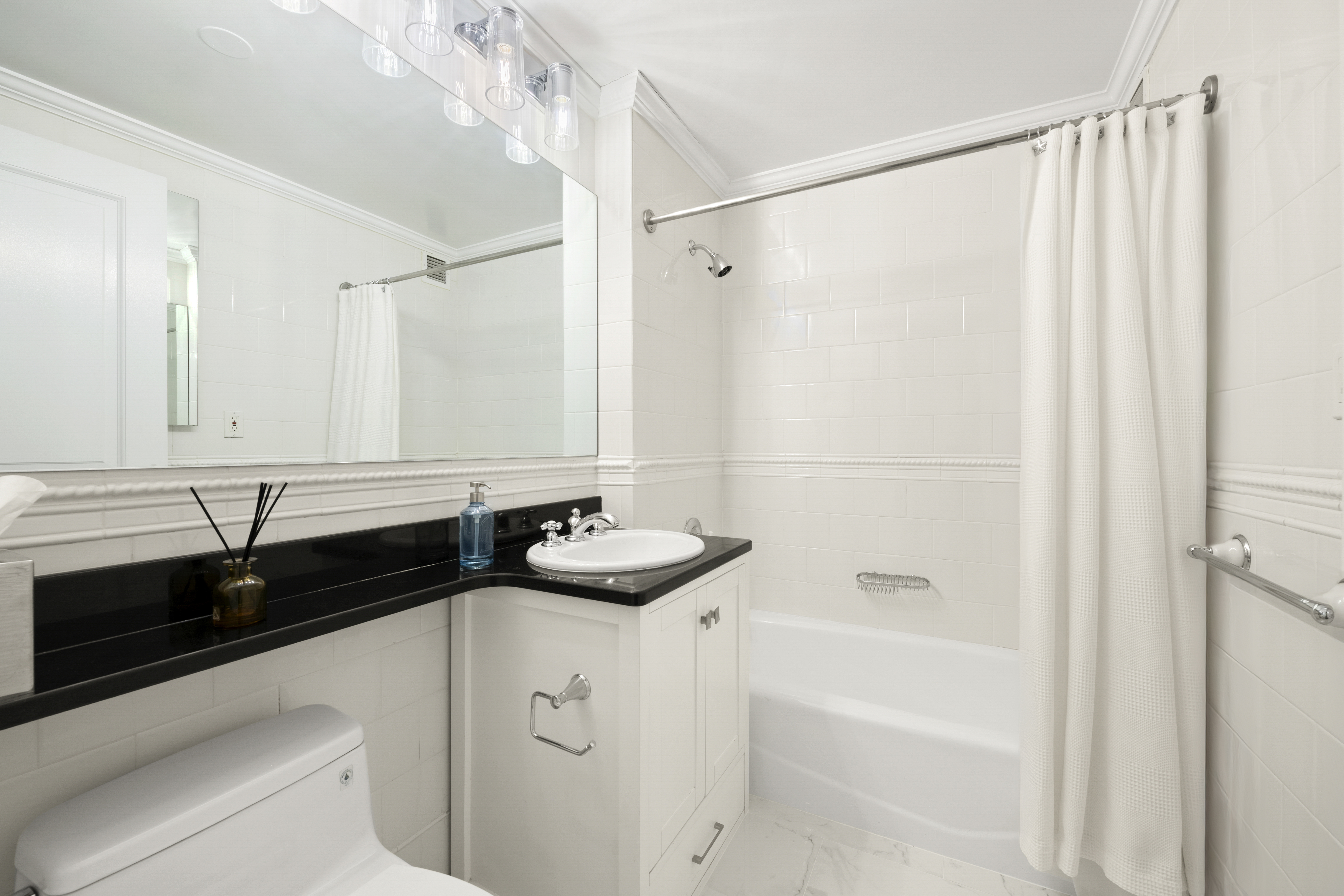404 East 76th Street, Unit 17A Manhattan, NY 10021 - Photo 12 of 18 a bathroom with a sink and a bathtub