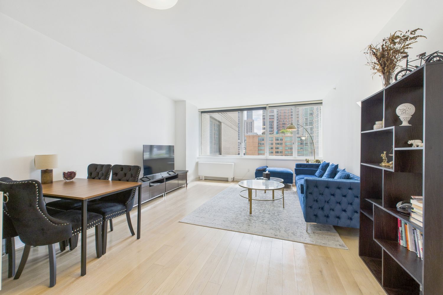 a living room with furniture a rug and a table