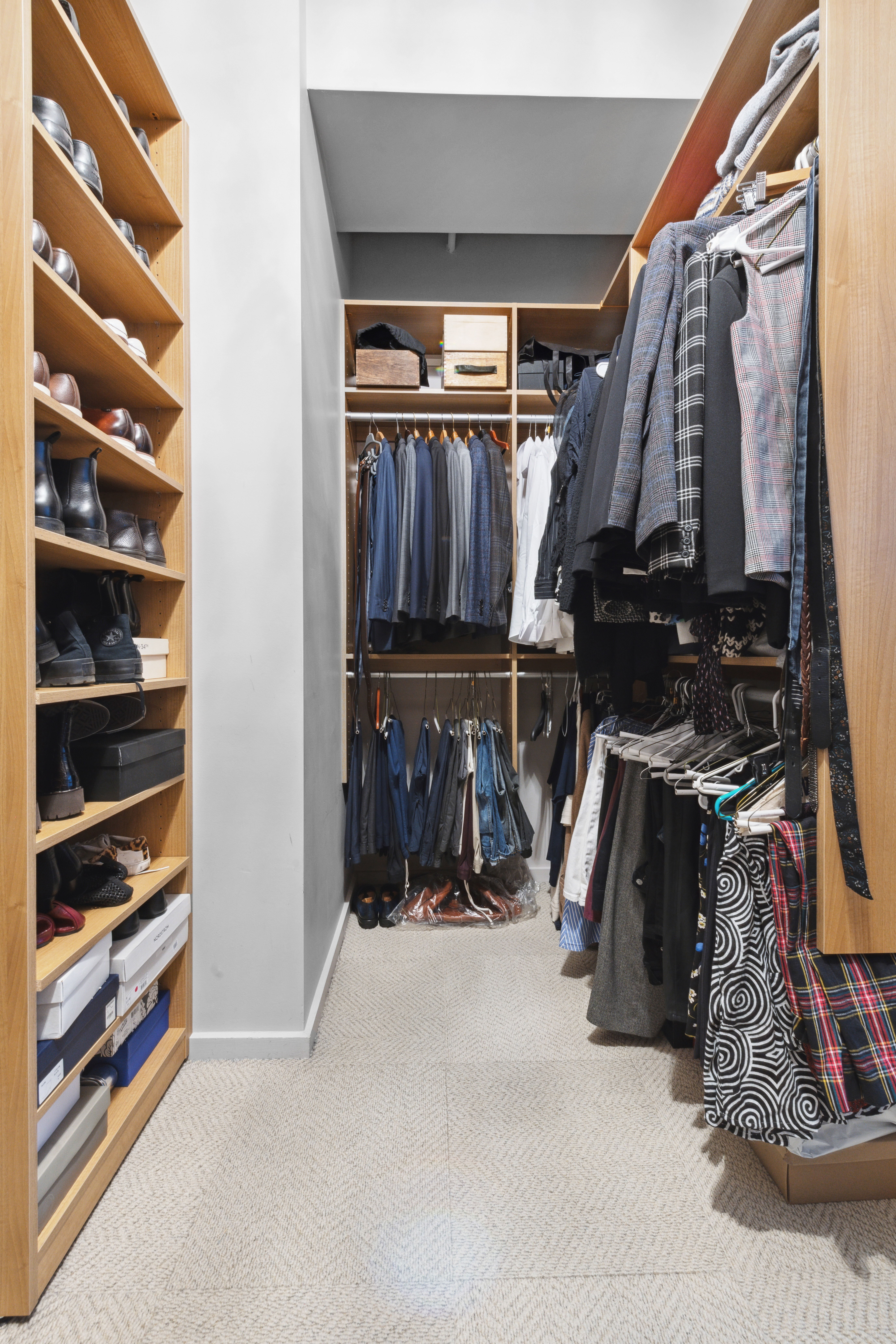 365 Bridge Street, Unit 12H Brooklyn, NY 11201 - Photo 5 of 12 a view of walk in closet with clothes and shoes