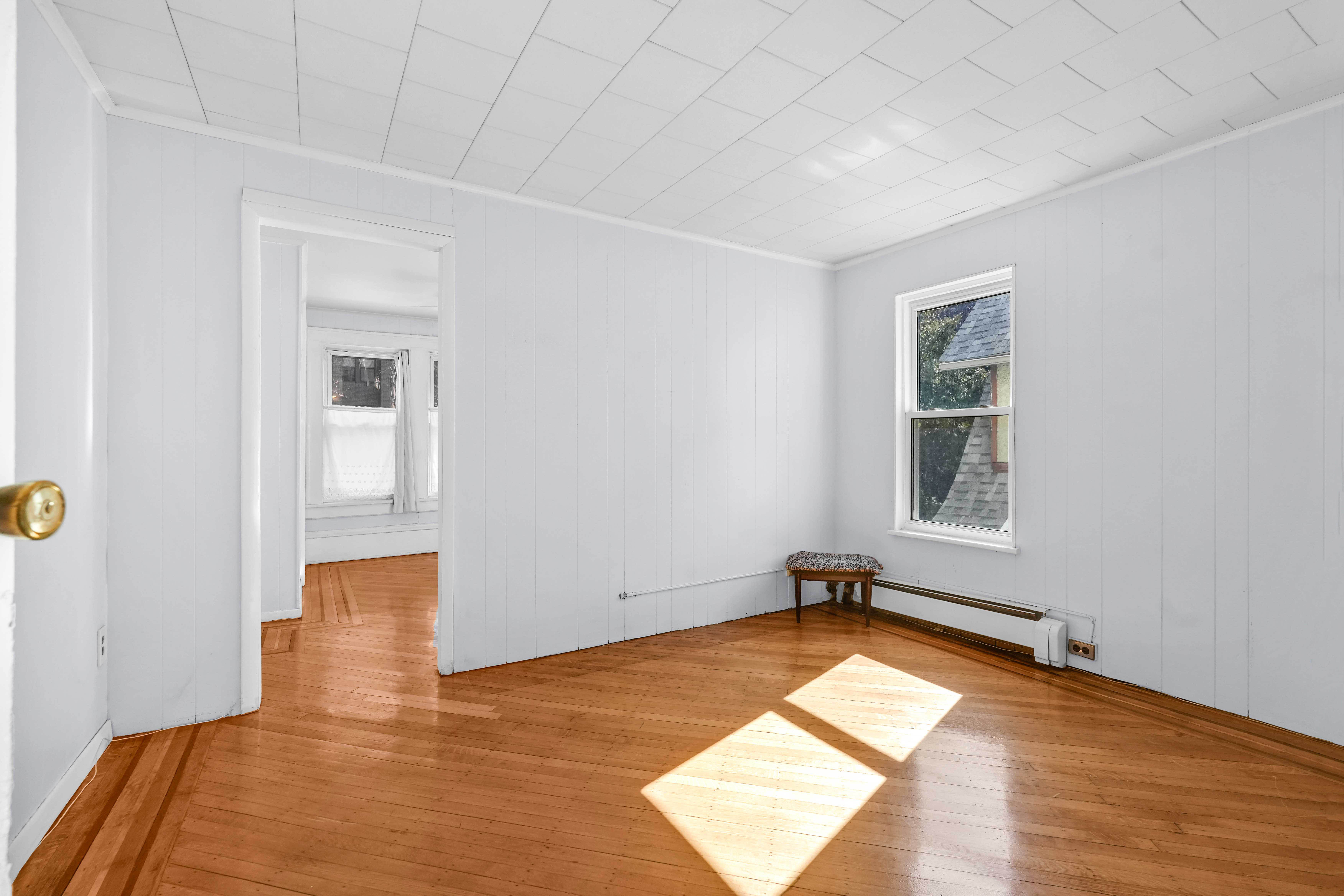 642 East 26th Street Brooklyn, NY 11210 - Photo 25 of 32 a view of empty room with wooden floor and fan