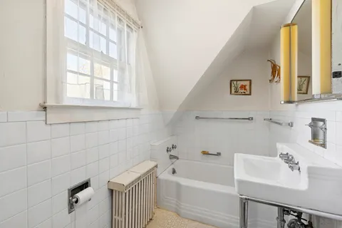 a kitchen with kitchen island granite countertop a sink stove and white cabinets