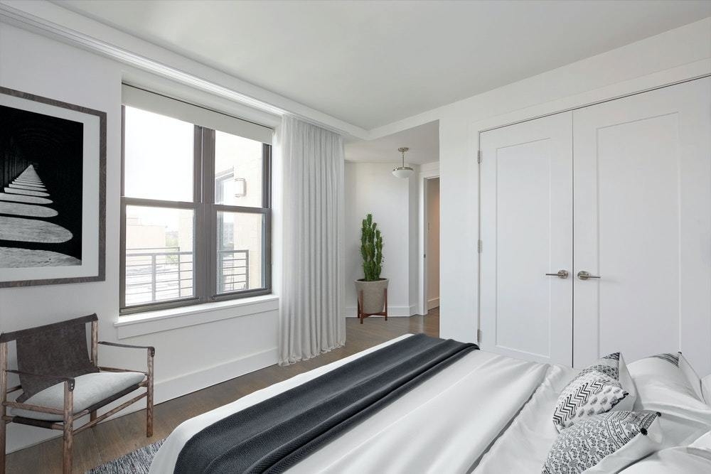 341 Eastern Parkway, Unit 8D Brooklyn, NY 11216 - Photo 3 of 7 a bedroom with a bed and a window with chair