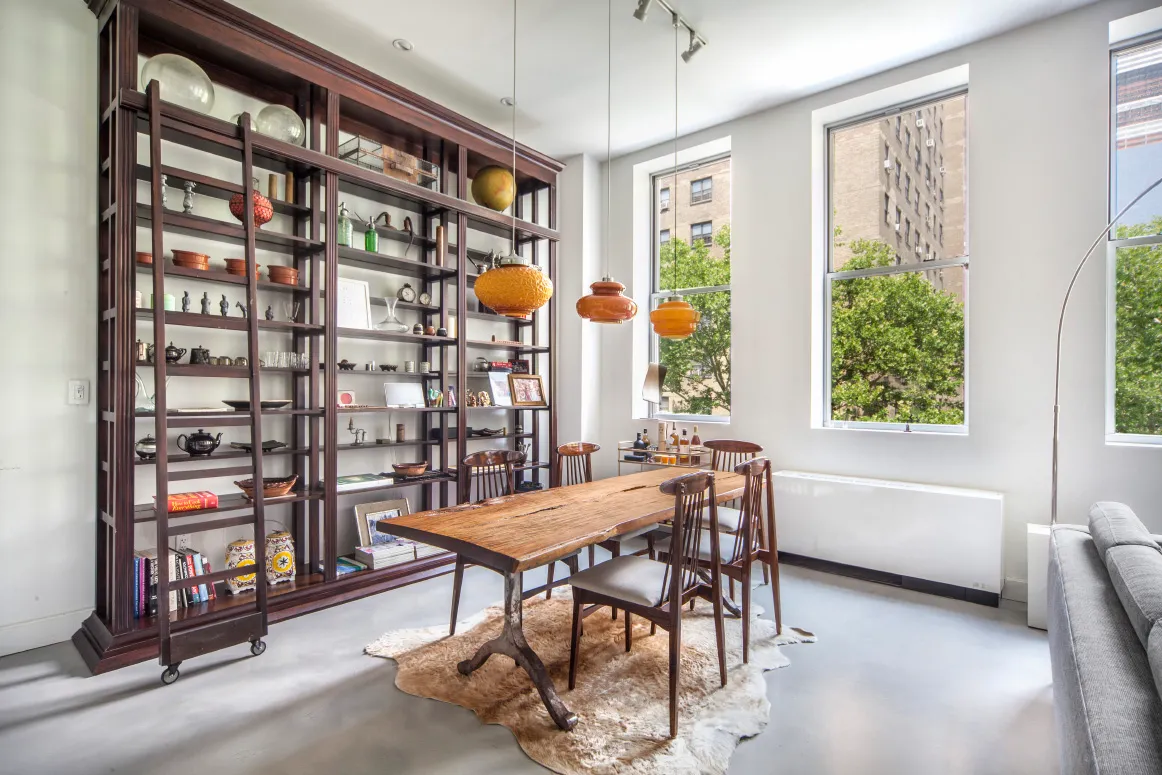a view of a dining room with furniture and a window