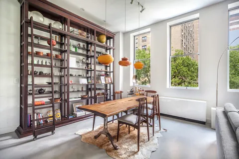 a view of a dining room with furniture and a window