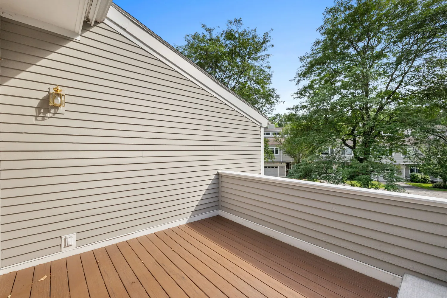 a view of a balcony with wooden floor and fence and a floor to ceiling window