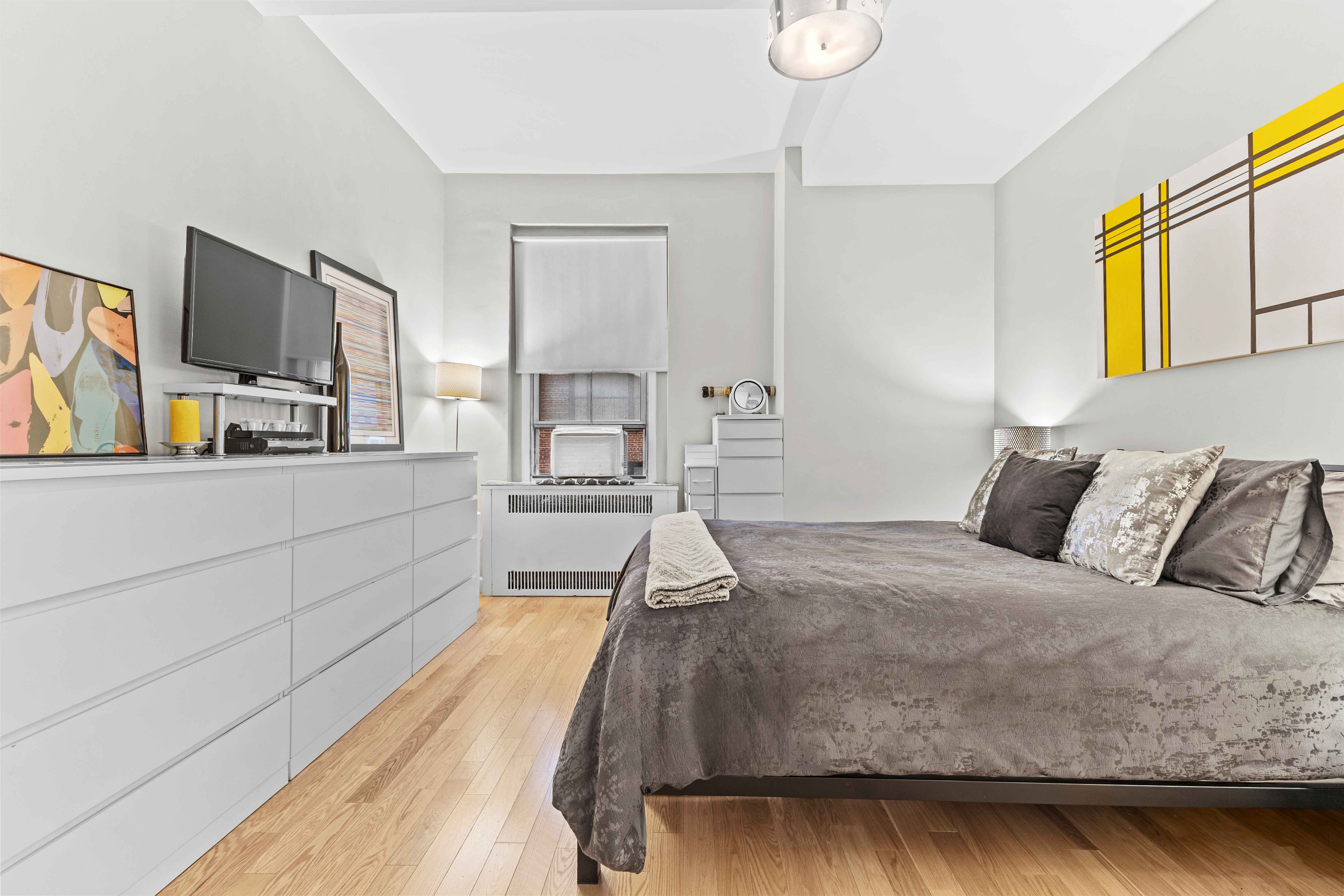 263 West End Avenue, Unit 6E Manhattan, NY 10023 - Photo 8 of 12 a spacious bedroom with a bed and flat screen tv