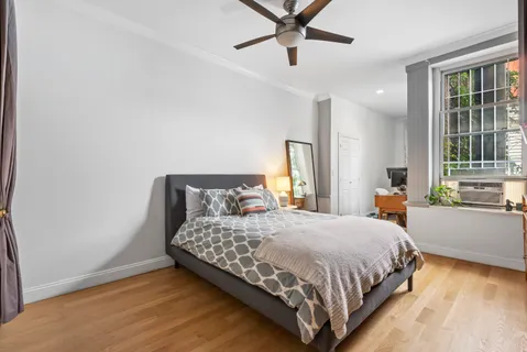 a bedroom with a bed and window