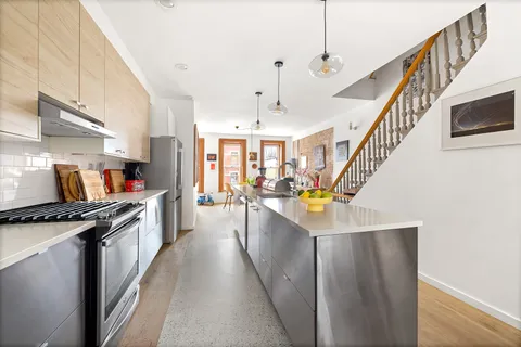 a kitchen view with counter top space a stove and a chandelier
