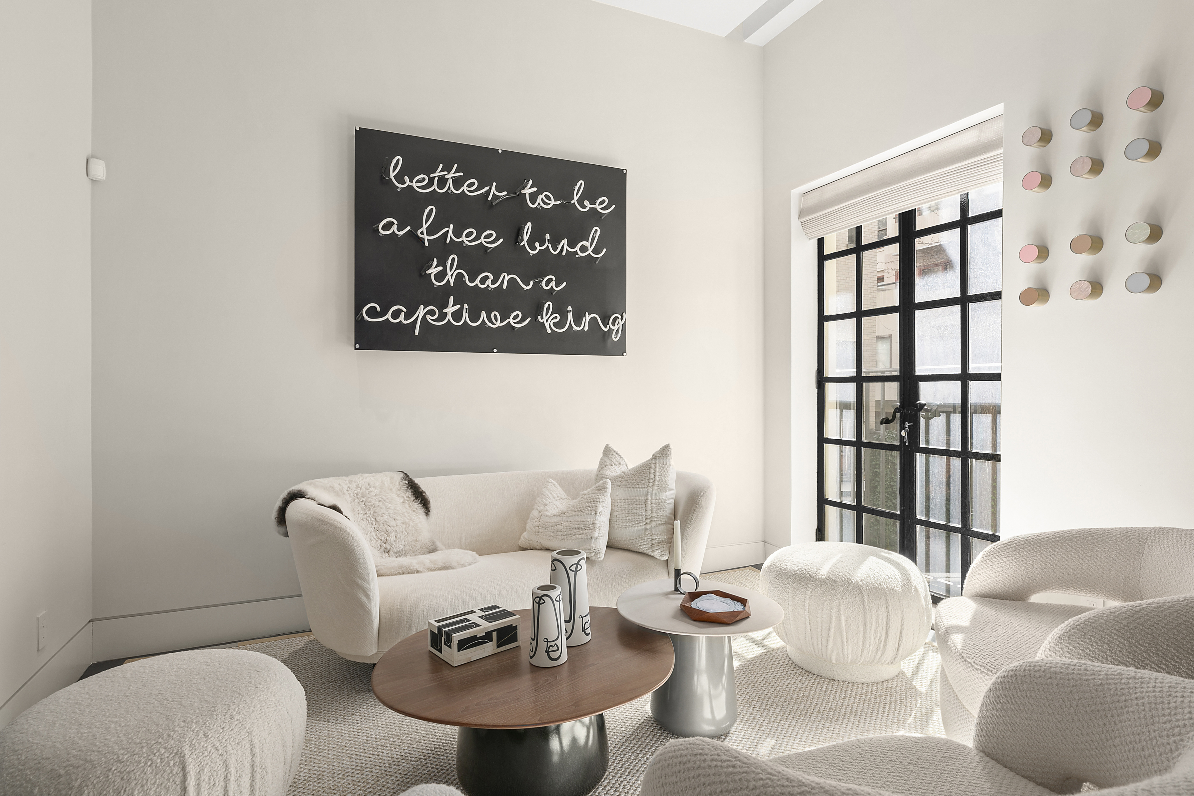36 East 64th Street Manhattan, NY 10065 - Photo 5 of 27 a living room with furniture and a large window