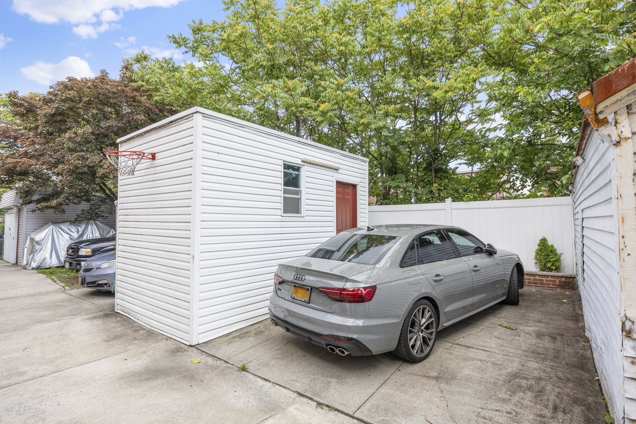 25-69 46th Street Queens, NY 11103 - Photo 32 of 33 a white car parked in front of a house