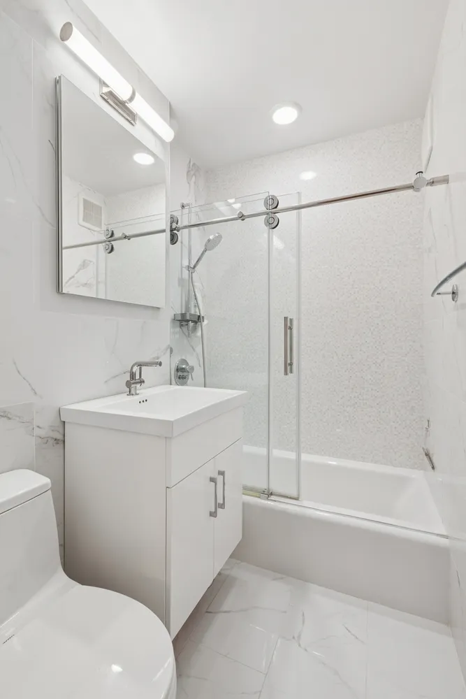 a bathroom with a sink toilet and shower