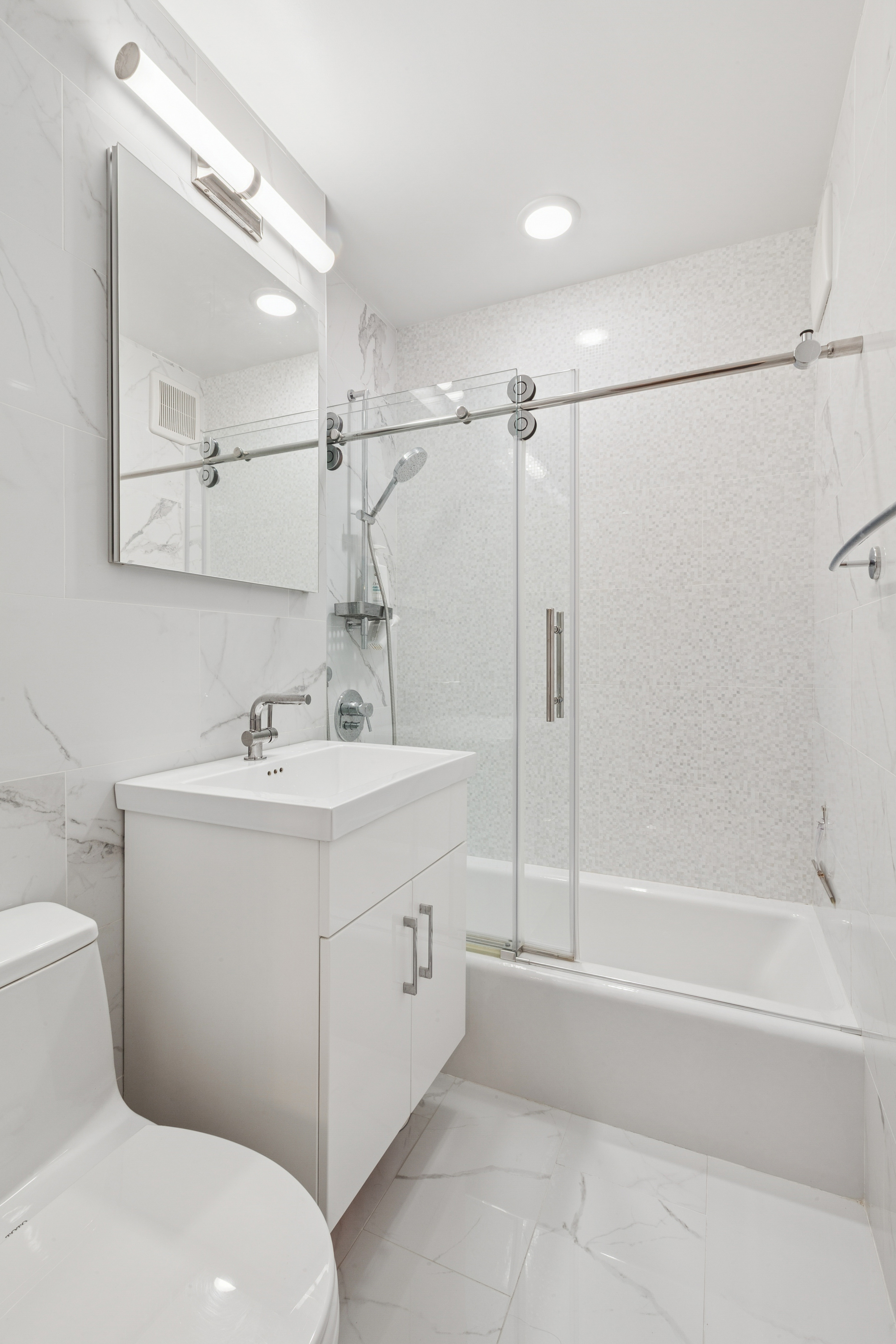 70-25 Yellowstone Boulevard, Unit 8N Queens, NY 11375 - Photo 5 of 19 a bathroom with a sink toilet and shower