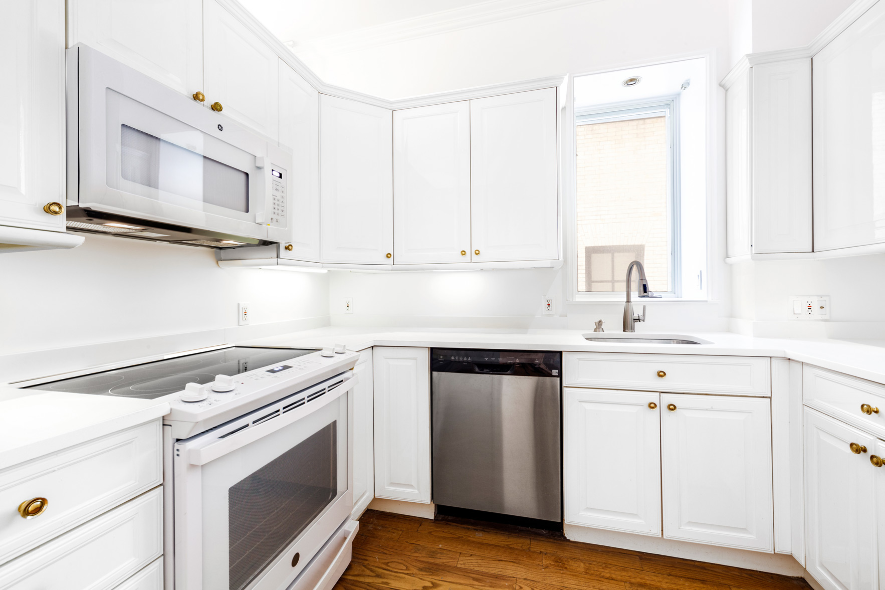34 East 64th Street, Unit 2 Manhattan, NY 10065 - Photo 4 of 7 a kitchen with cabinets appliances and a sink