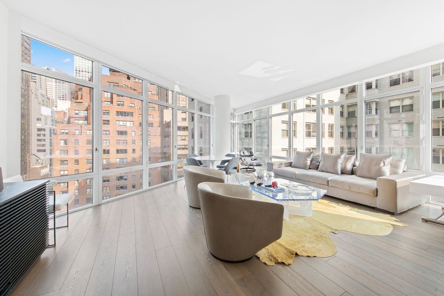 207 East 57th Street, Unit 12A Manhattan, NY 10022 - Photo 2 of 13 a living room with furniture and a large window