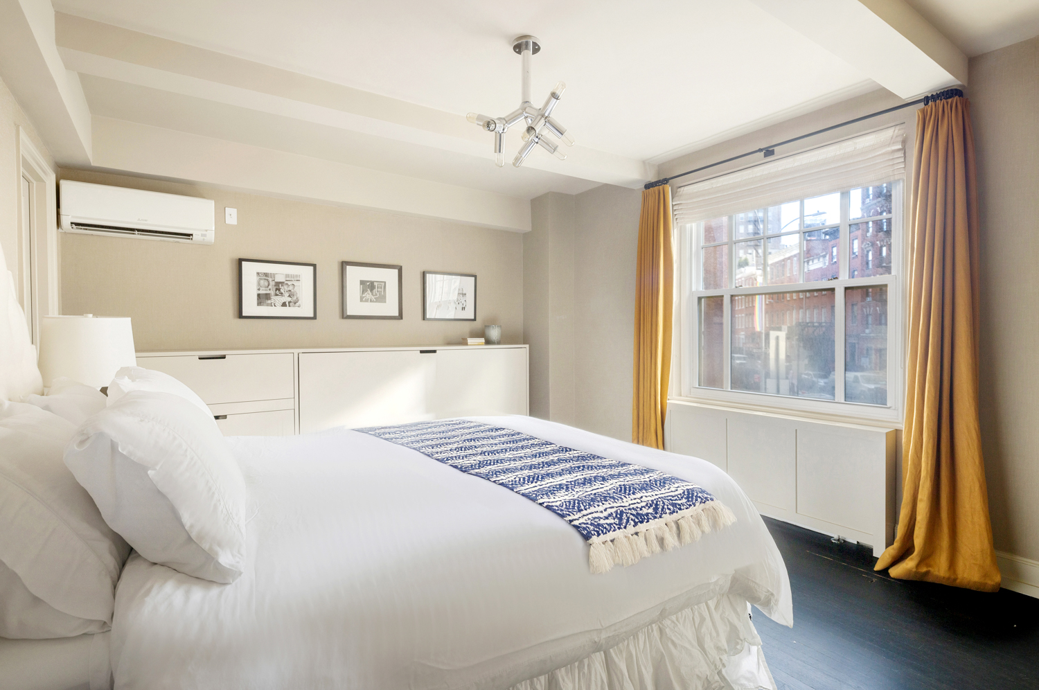 45 Christopher Street, Unit 2E Manhattan, NY 10014 - Photo 12 of 15 a bedroom with a large bed and a window