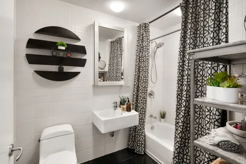 a bathroom with a sink toilet and shower