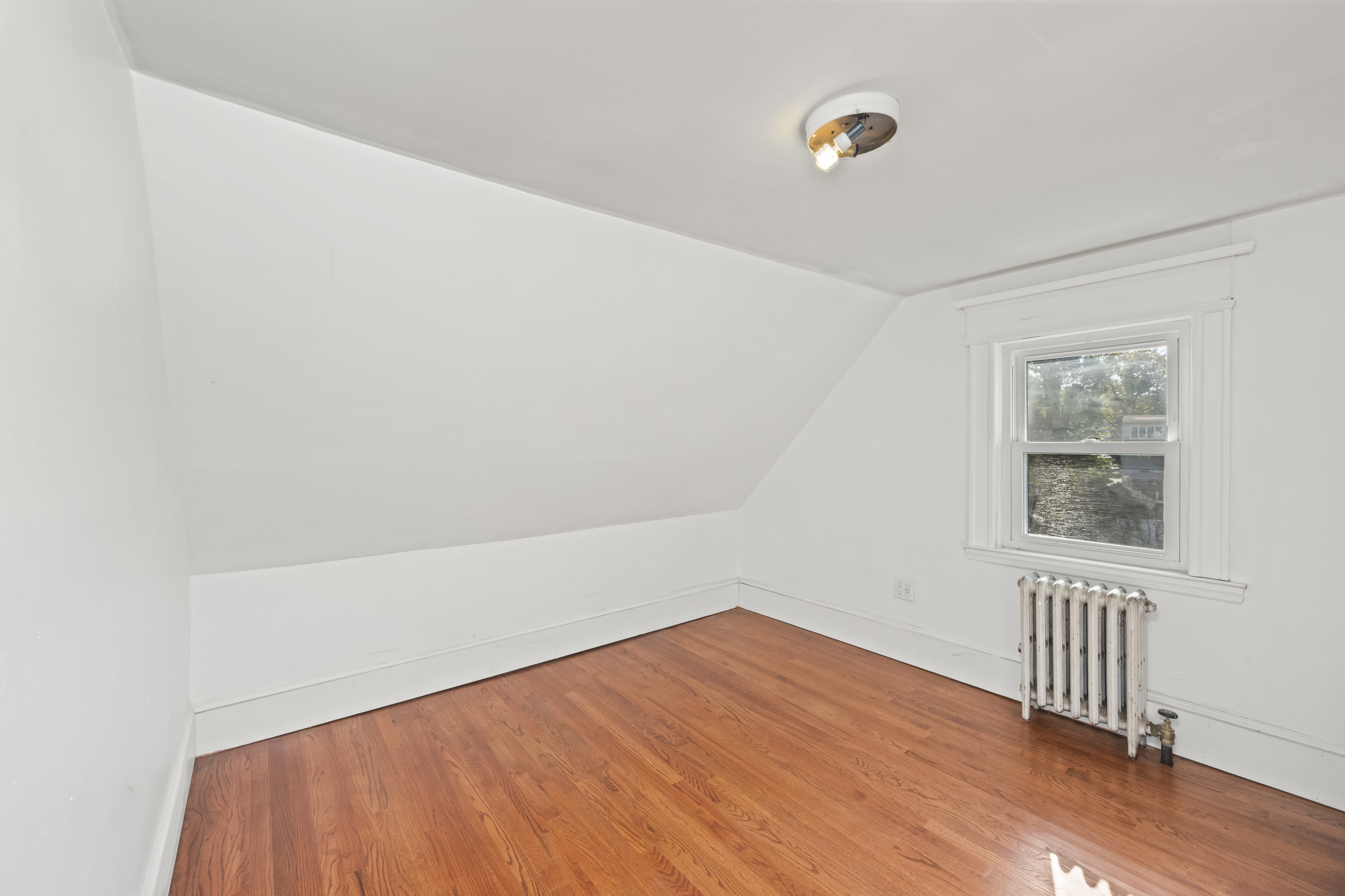 704 Delafield Avenue Staten Island, NY 10310 - Photo 21 of 35 a view of empty room with wooden floor and fan