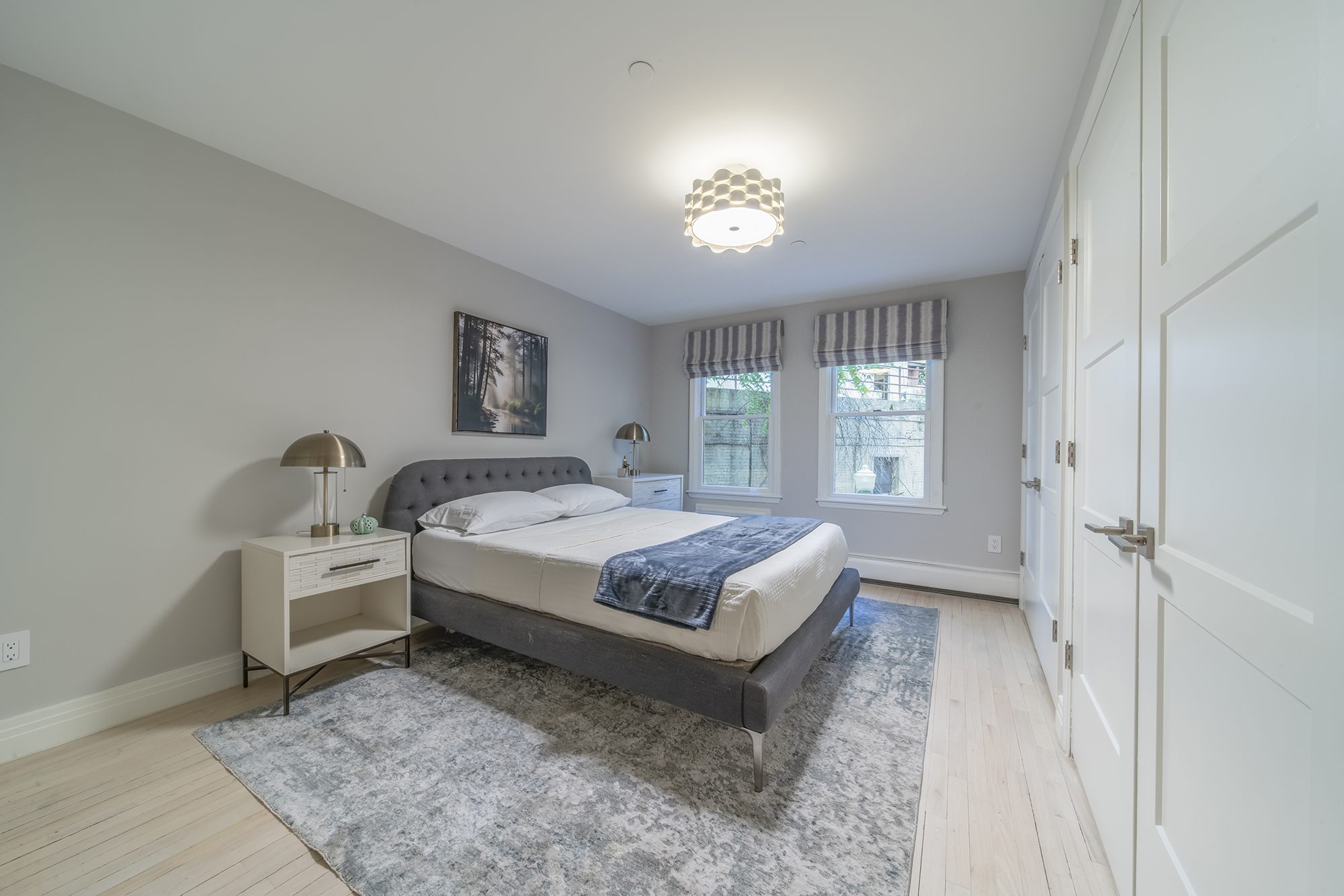 407 East 12th Street, Unit 1RSE Manhattan, NY 10009 - Photo 8 of 13 a spacious bedroom with a bed and a window