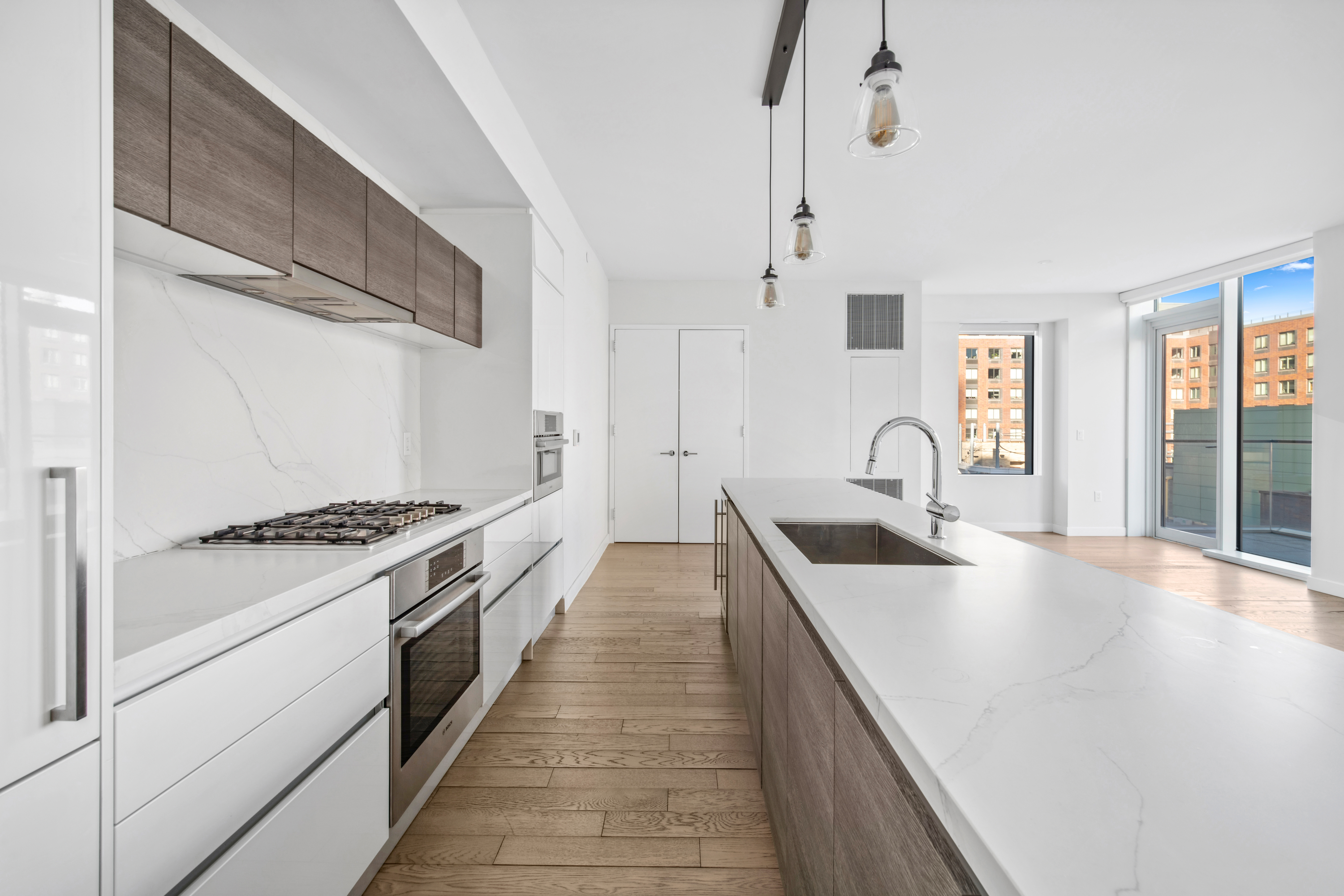 505-513 West 43rd Street, Unit 10B Manhattan, NY 10036 - Photo 4 of 22 a kitchen with granite countertop a stove and a sink