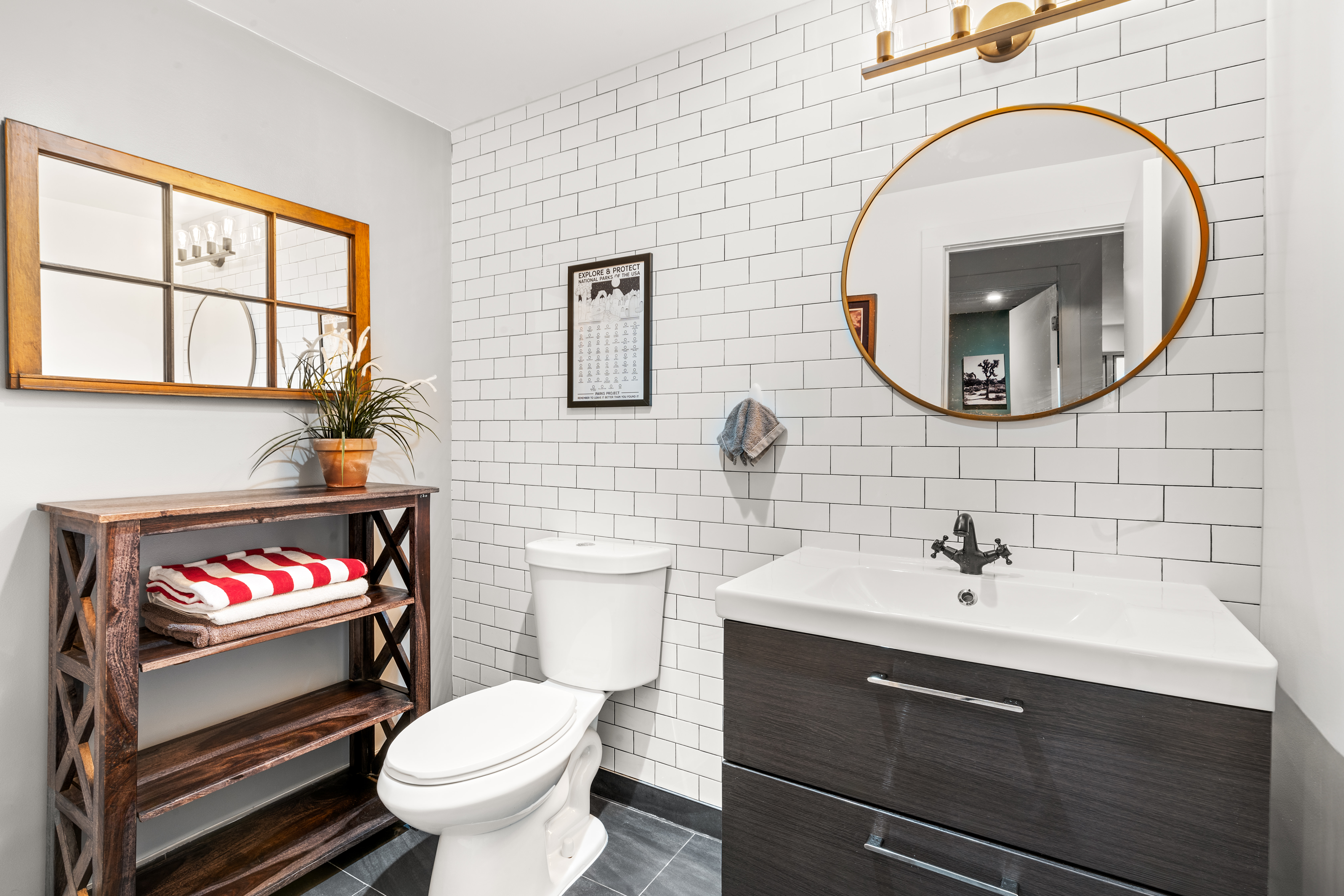 319 Humboldt Street, Unit 1A Brooklyn, NY 11211 - Photo 3 of 10 a bathroom with a sink a toilet and a mirror