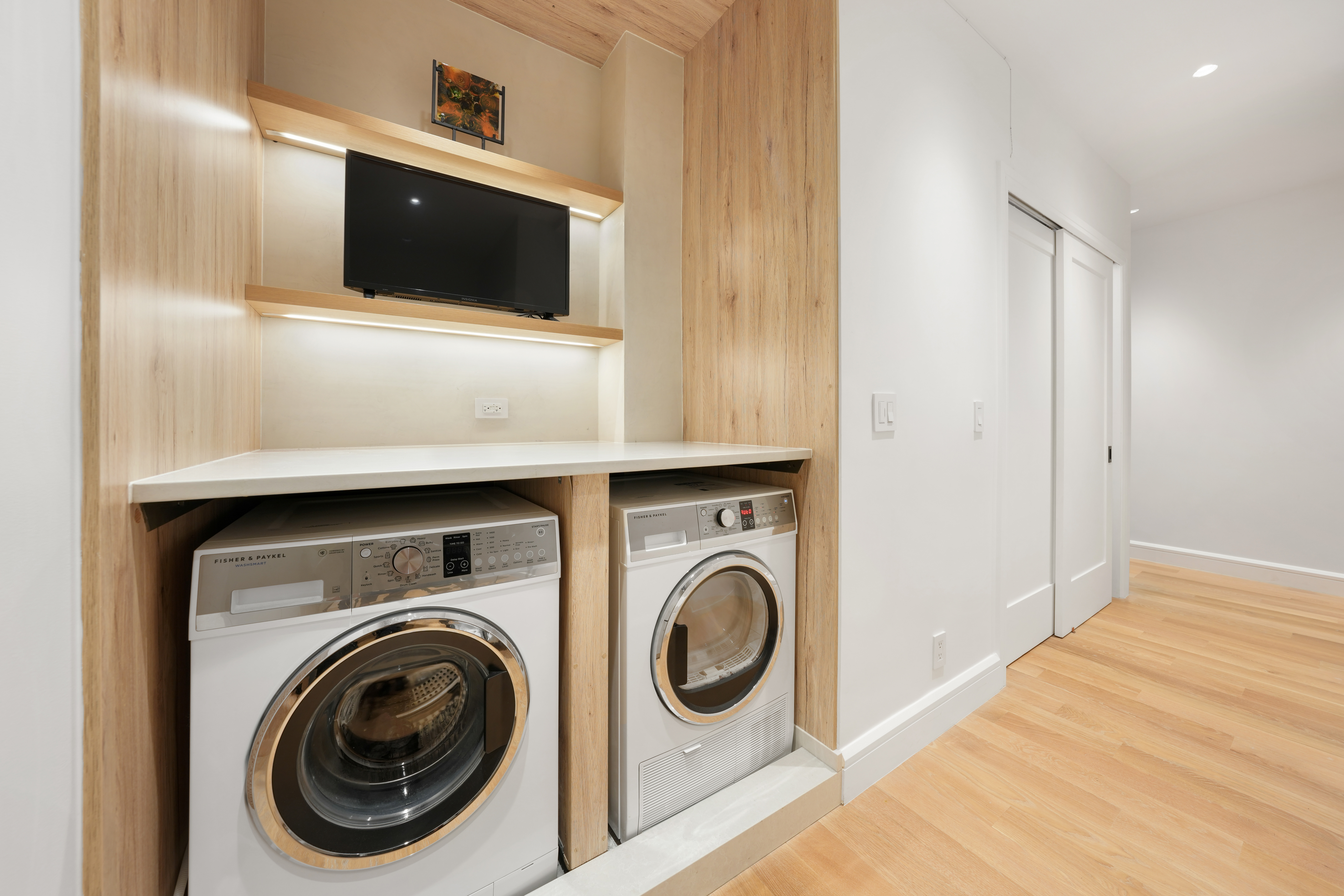 176 West 87th Street, Unit 1H Manhattan, NY 10024 - Photo 8 of 19 a living room with a flat screen tv and washer