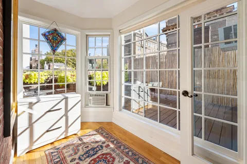 a bed sitting in front of a window