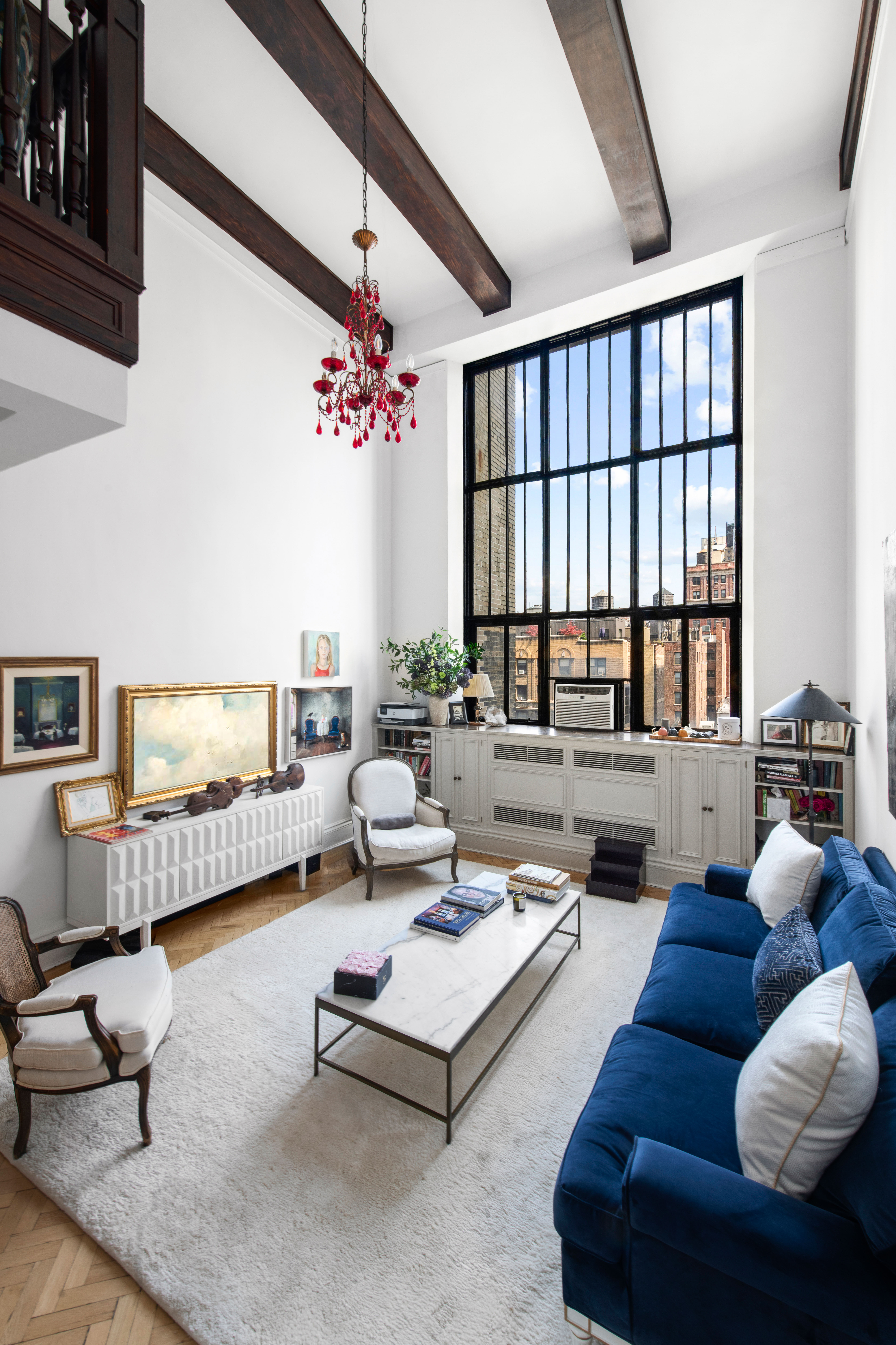 1 West 67th Street, Unit 608 Manhattan, NY 10023 - Photo 2 of 16 a living room with furniture and a large window