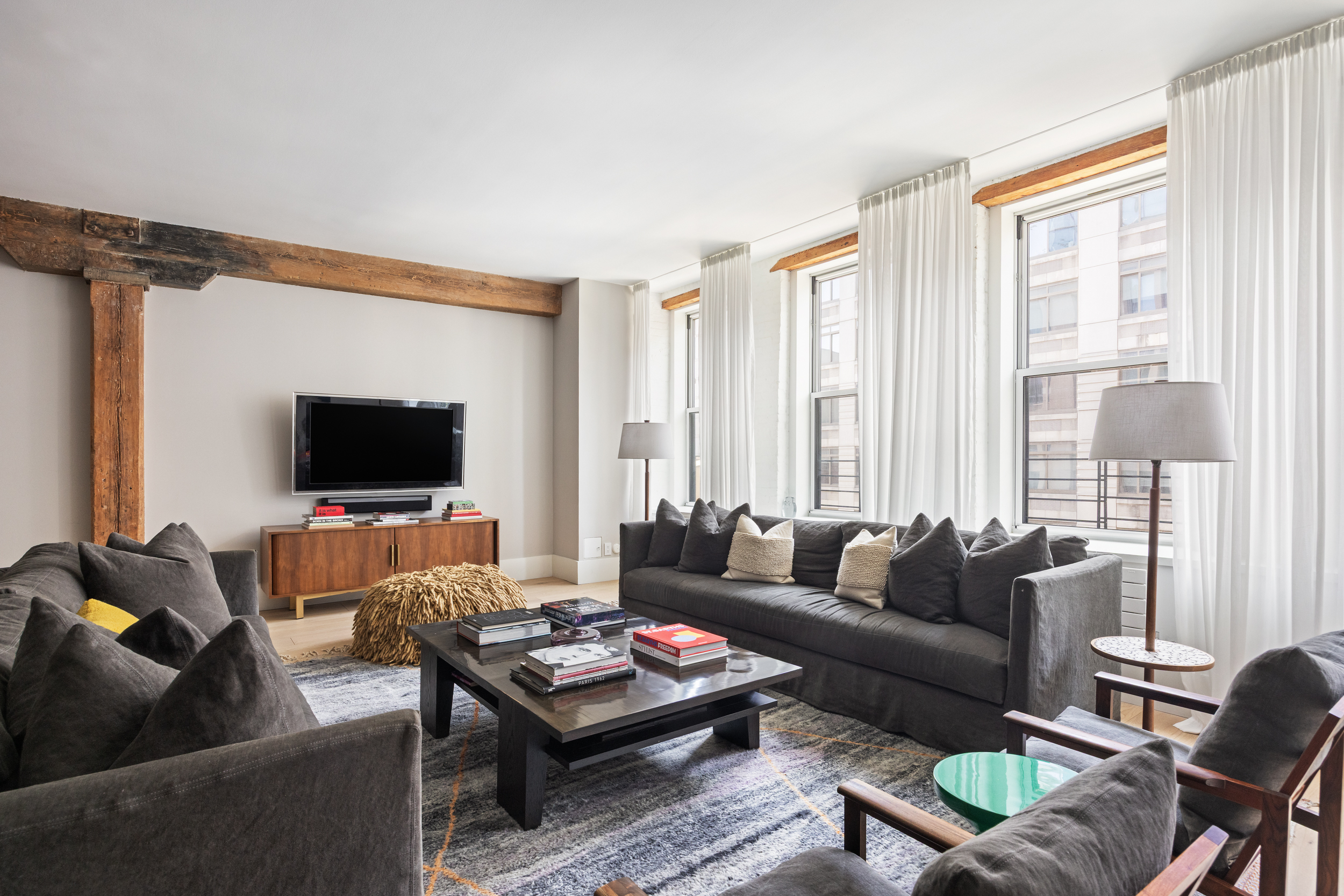 622 Greenwich Street, Unit 4B Manhattan, NY 10014 - Photo 8 of 27 a living room with furniture a flat screen tv and a window