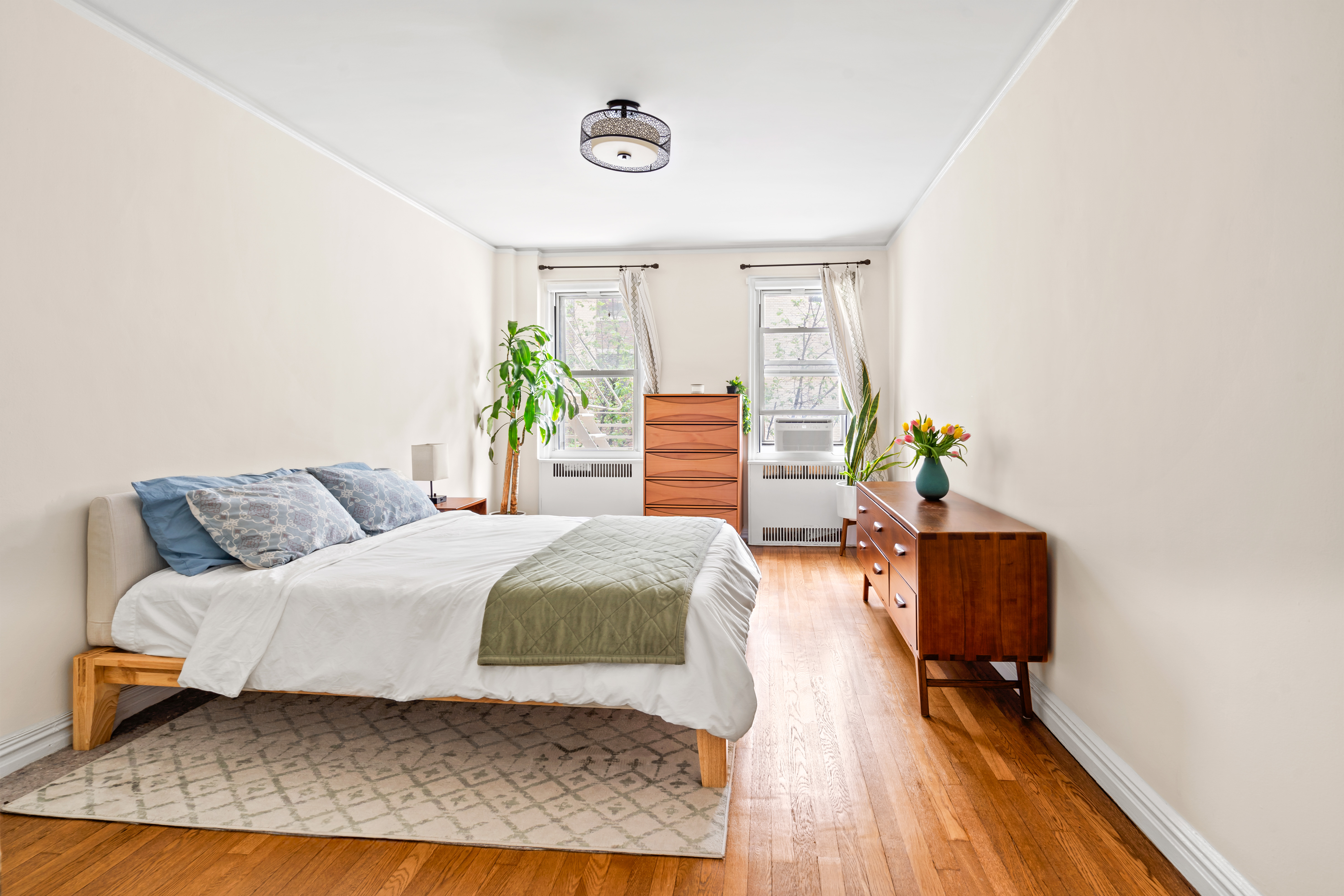 225 West 25th Street, Unit 5D Manhattan, NY 10001 - Photo 5 of 16 a bedroom with a bed and wooden floor