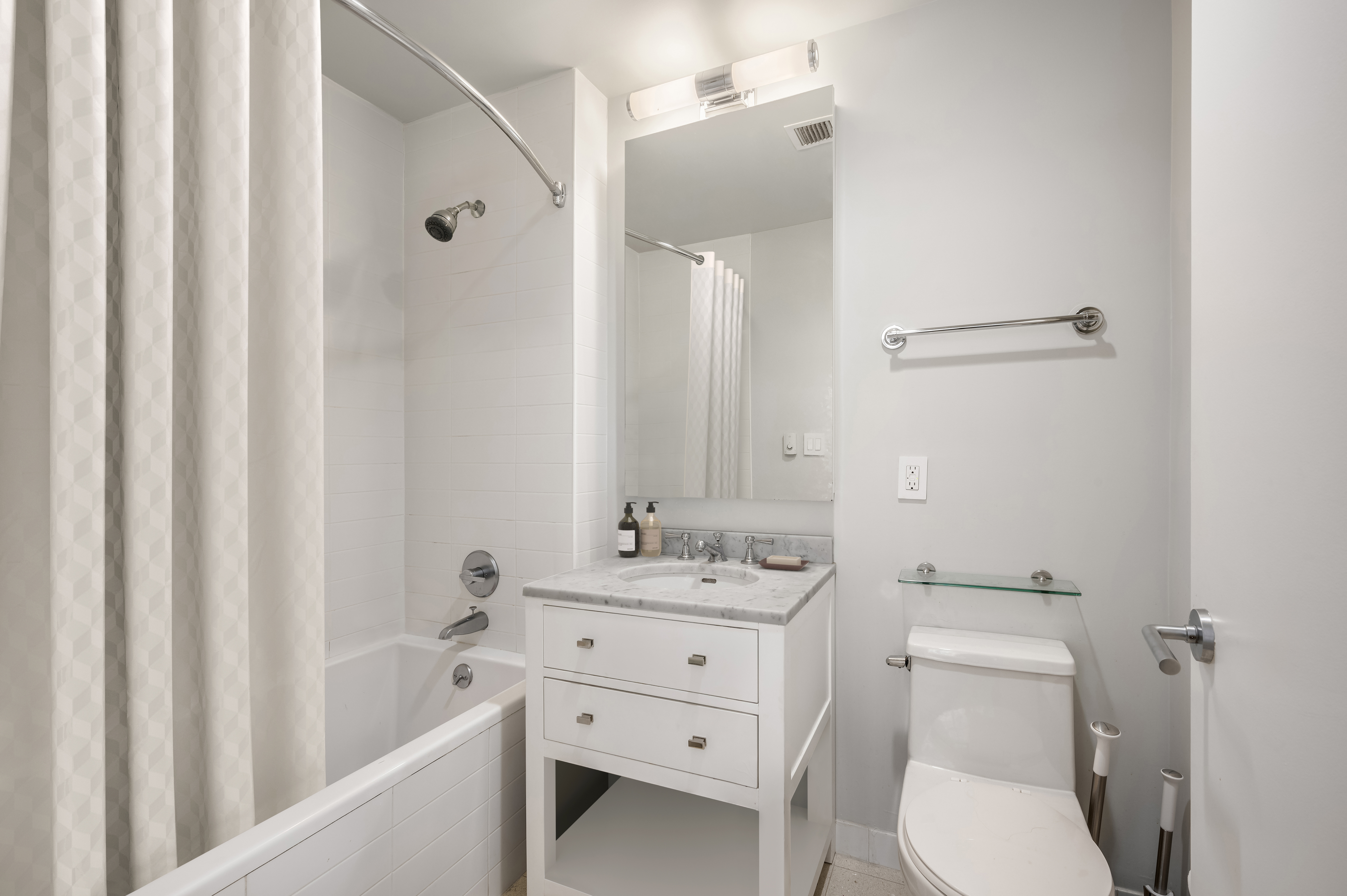 125 West 22nd Street, Unit 8B Manhattan, NY 10011 - Photo 9 of 10 a bathroom with a sink a toilet and shower