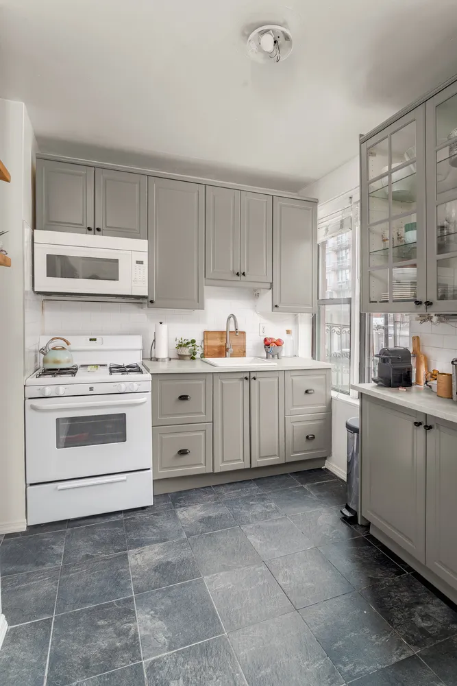 a kitchen with a stove a sink and a refrigerator