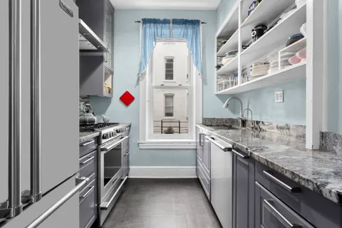a kitchen with stainless steel appliances granite countertop a stove and a sink