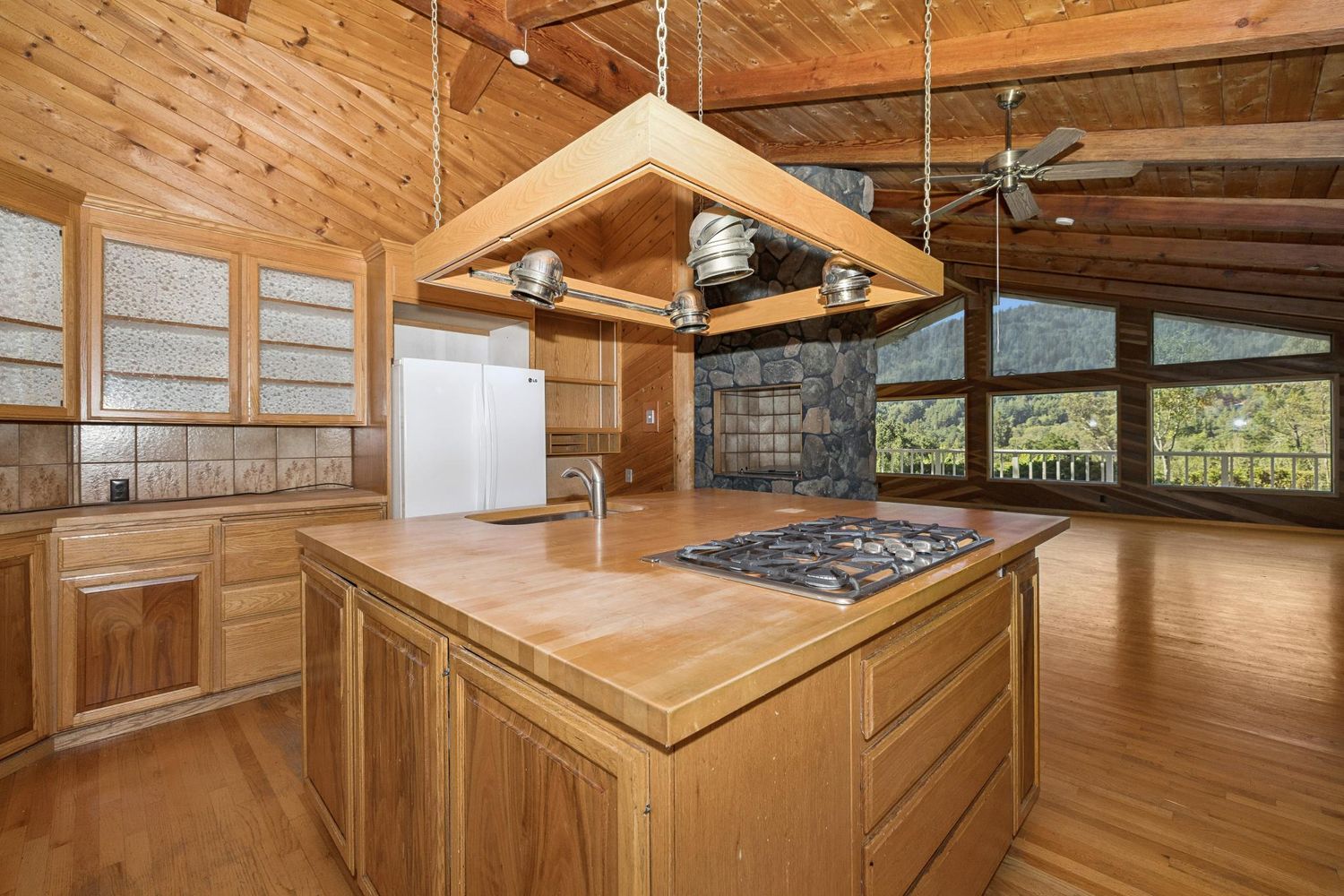 a kitchen that has a stove and a table in it