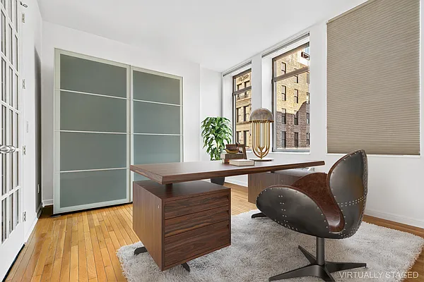 252 7th Avenue, Unit 10I Manhattan, NY 10001 - Photo 12 of 25 a living room with furniture and a potted plant