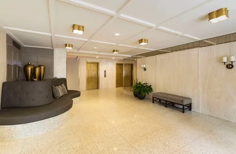 a living room with furniture and a white wall