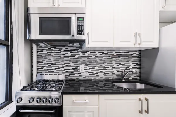 a kitchen with a stove and a microwave