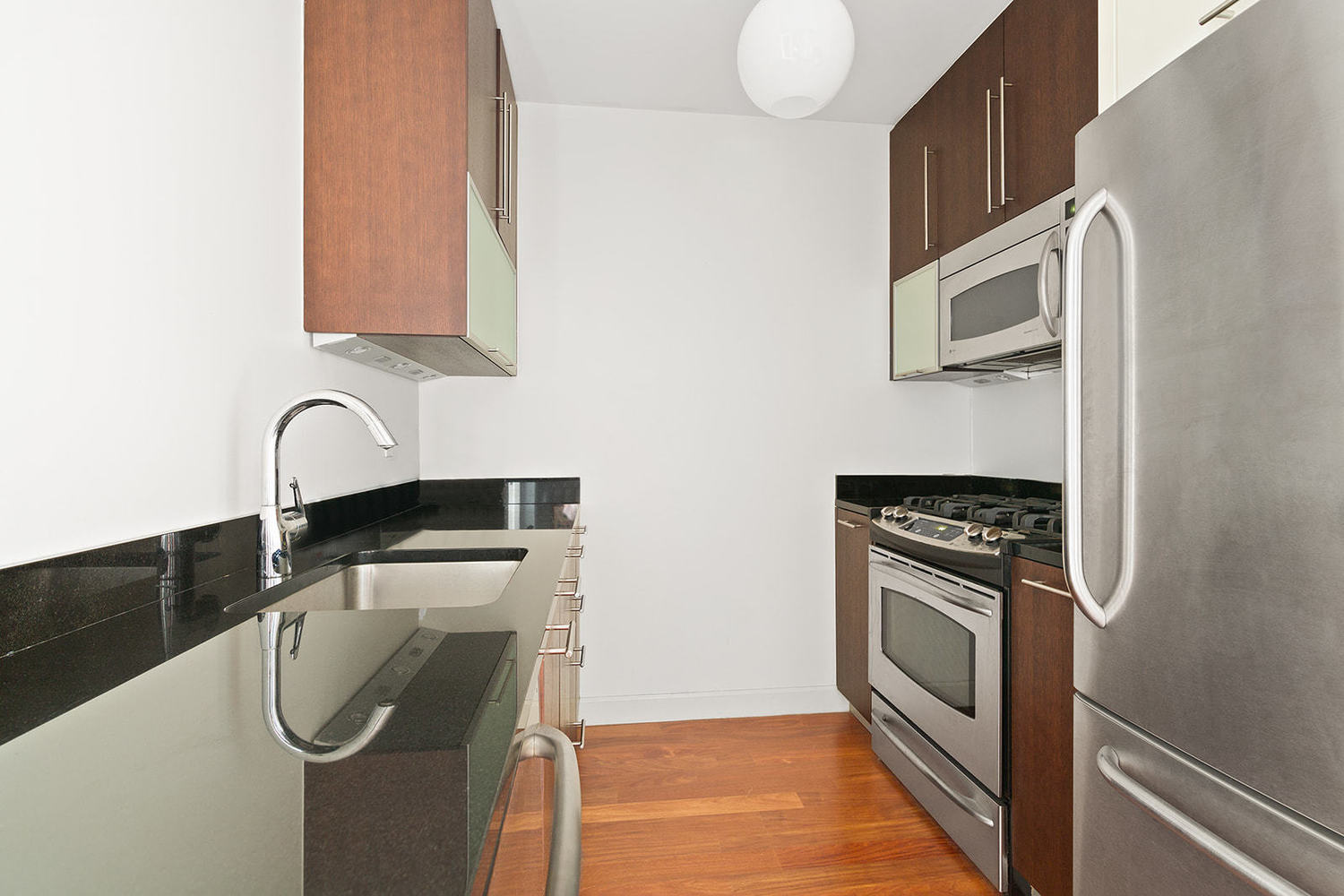 100 Jay Street, Unit 10J Brooklyn, NY 11201 - Photo 4 of 9 a kitchen with a sink a stove and cabinets