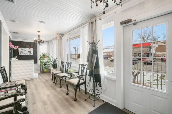 a living room with furniture and a chandelier