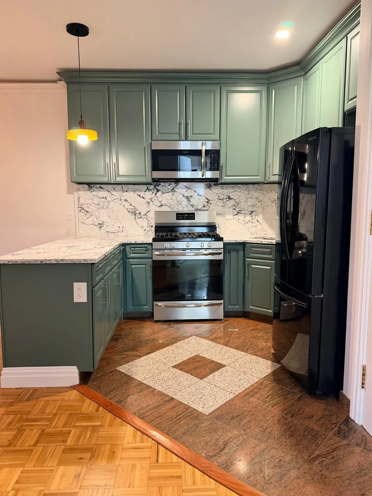 a kitchen with stainless steel appliances granite countertop a sink stove and refrigerator