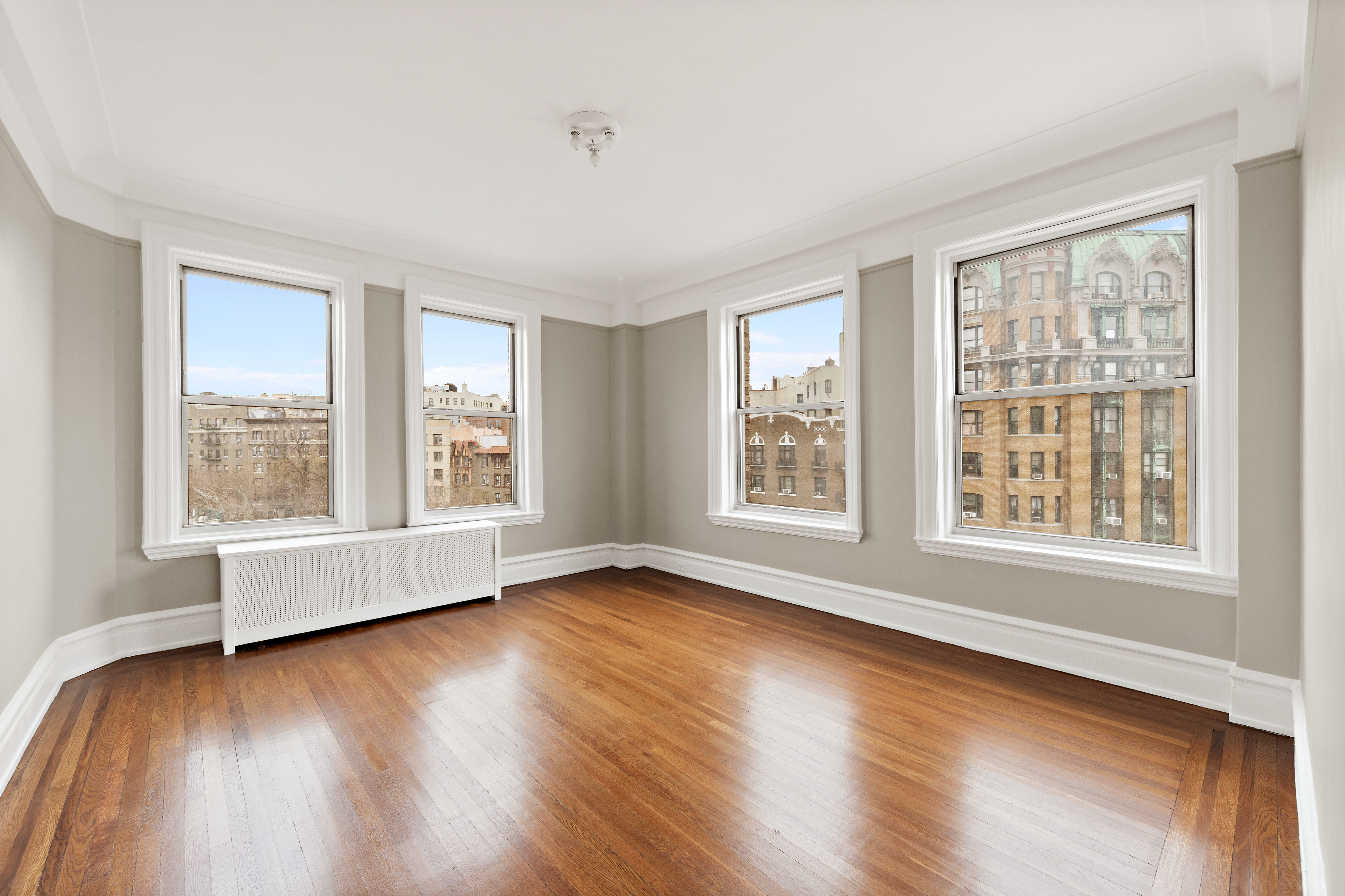 800 Riverside Drive, Unit 6E Manhattan, NY 10032 - Photo 8 of 30 a view of an empty room with wooden floor and a window