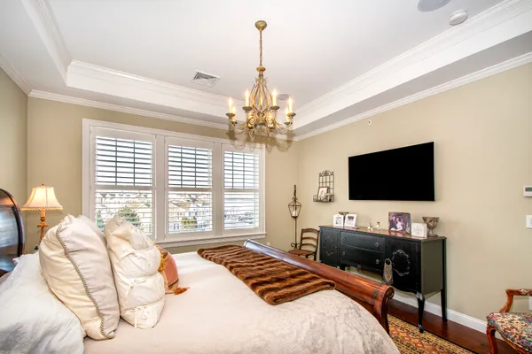 a bedroom with a bed and ceiling fan