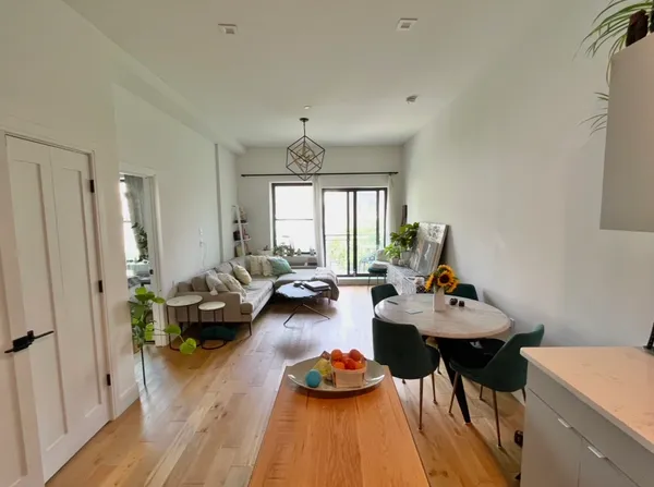 a living room with furniture and a wooden floor