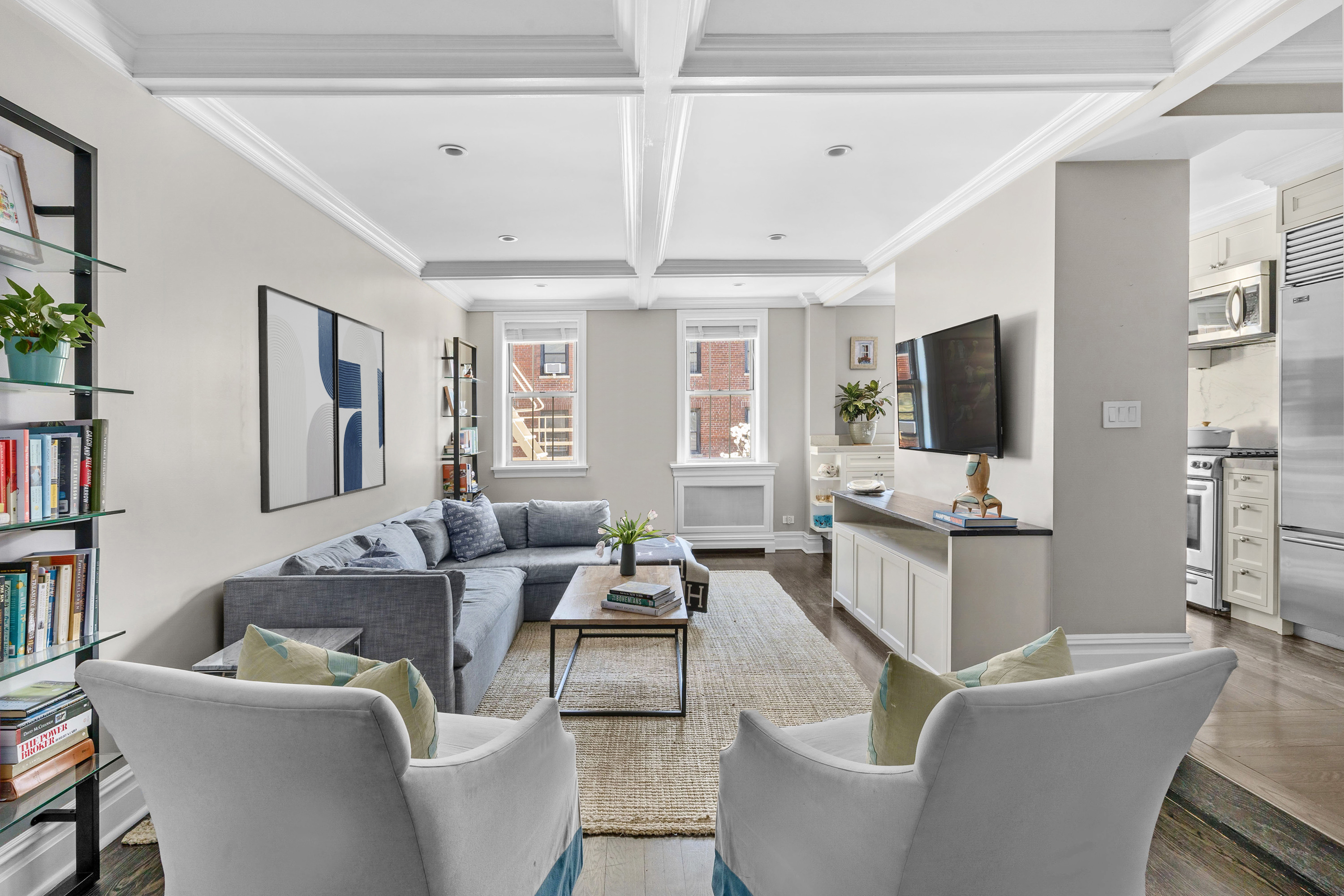 75 Bank Street, Unit 3K Manhattan, NY 10014 - Photo 1 of 11 a living room with furniture a flat screen tv and a book shelf