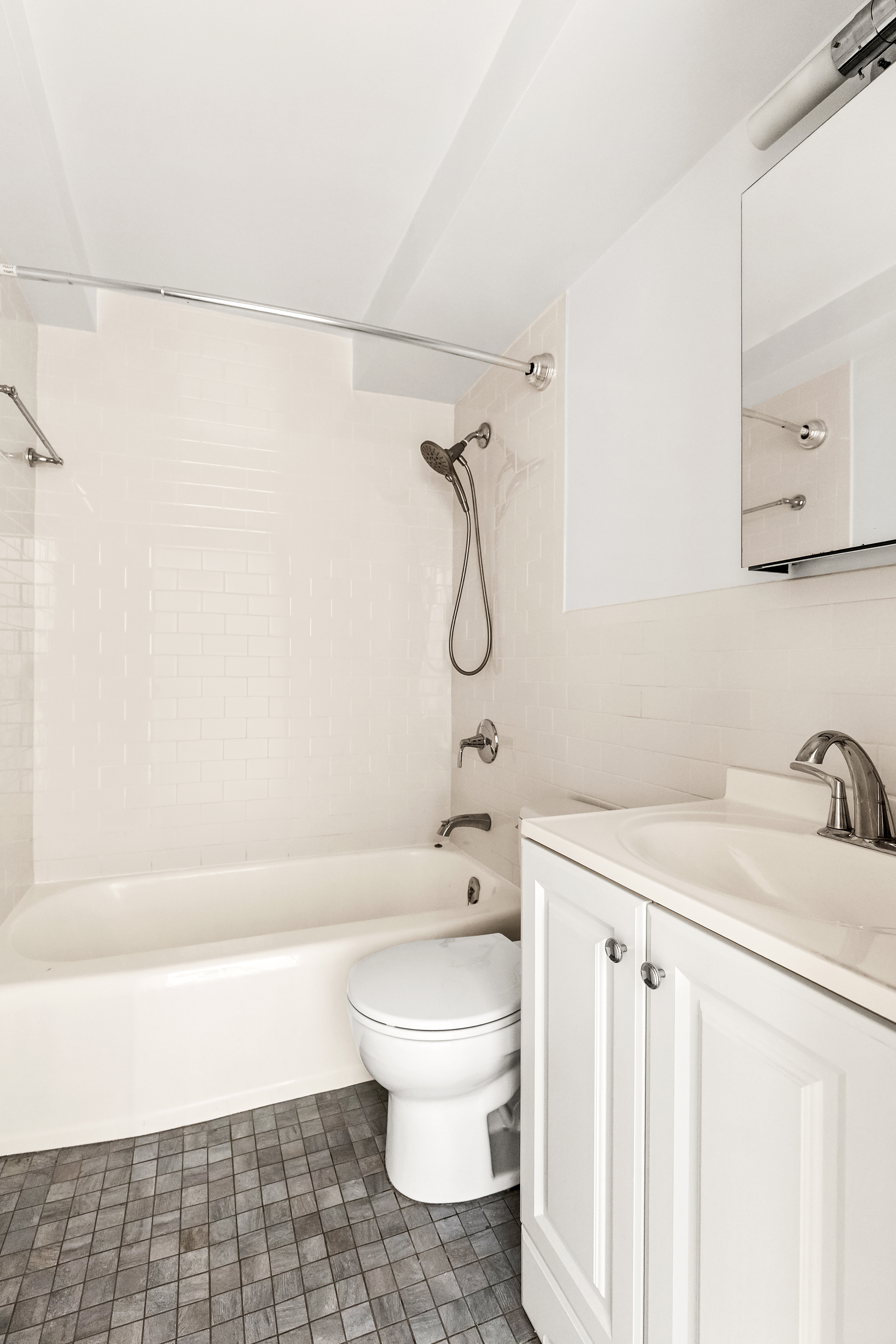 315 East 70th Street, Unit 4C Manhattan, NY 10021 - Photo 3 of 6 a bathroom with a toilet sink and shower