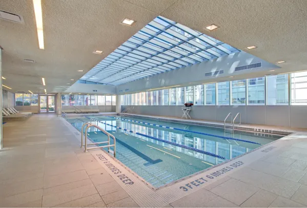 a backyard of a residential building with barbeque oven table and chairs