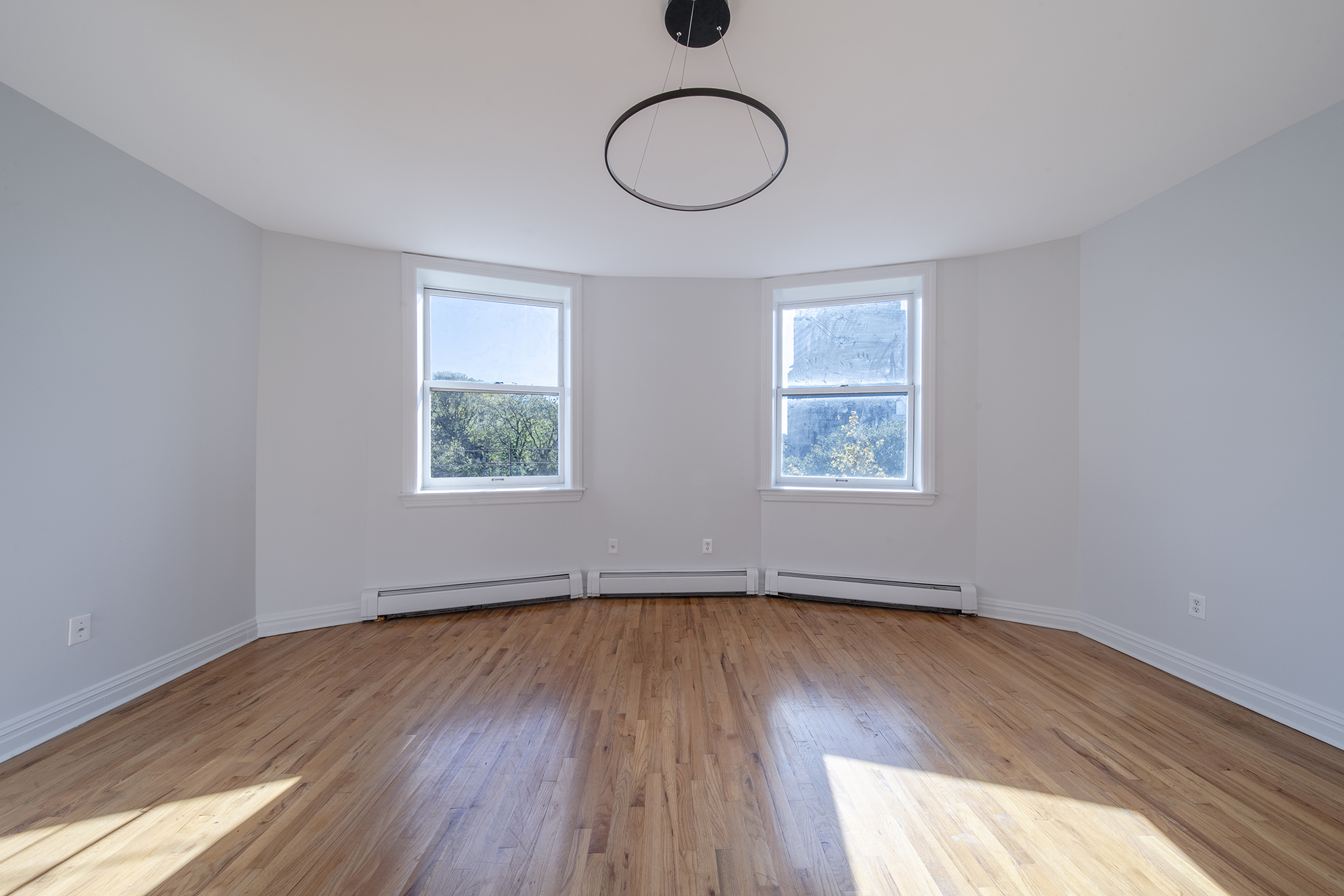 7 Mt Morris Park West, Unit D Manhattan, NY 10027 - Photo 7 of 16 a view of an empty room with wooden floor and window